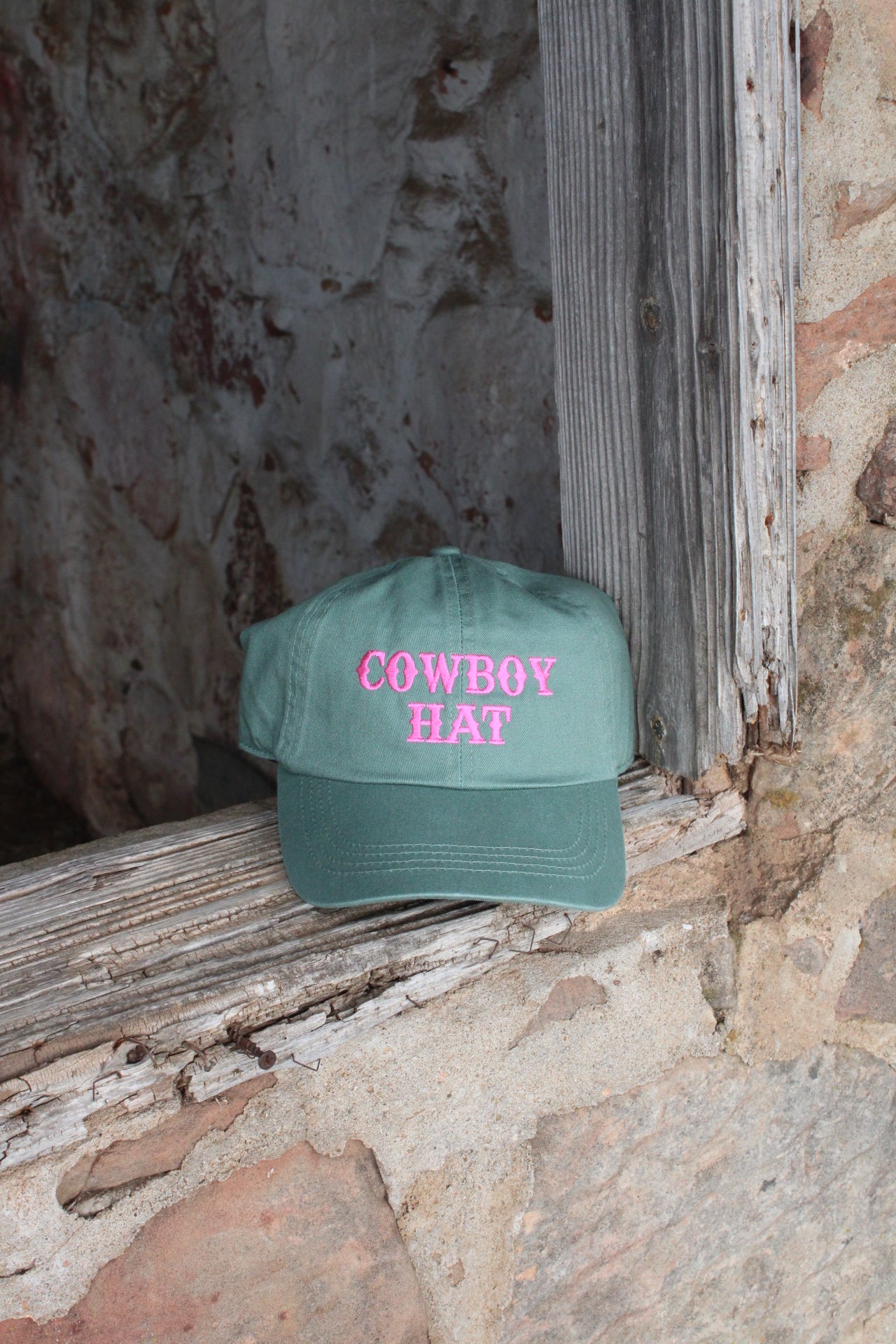 green hat with pink embroidery