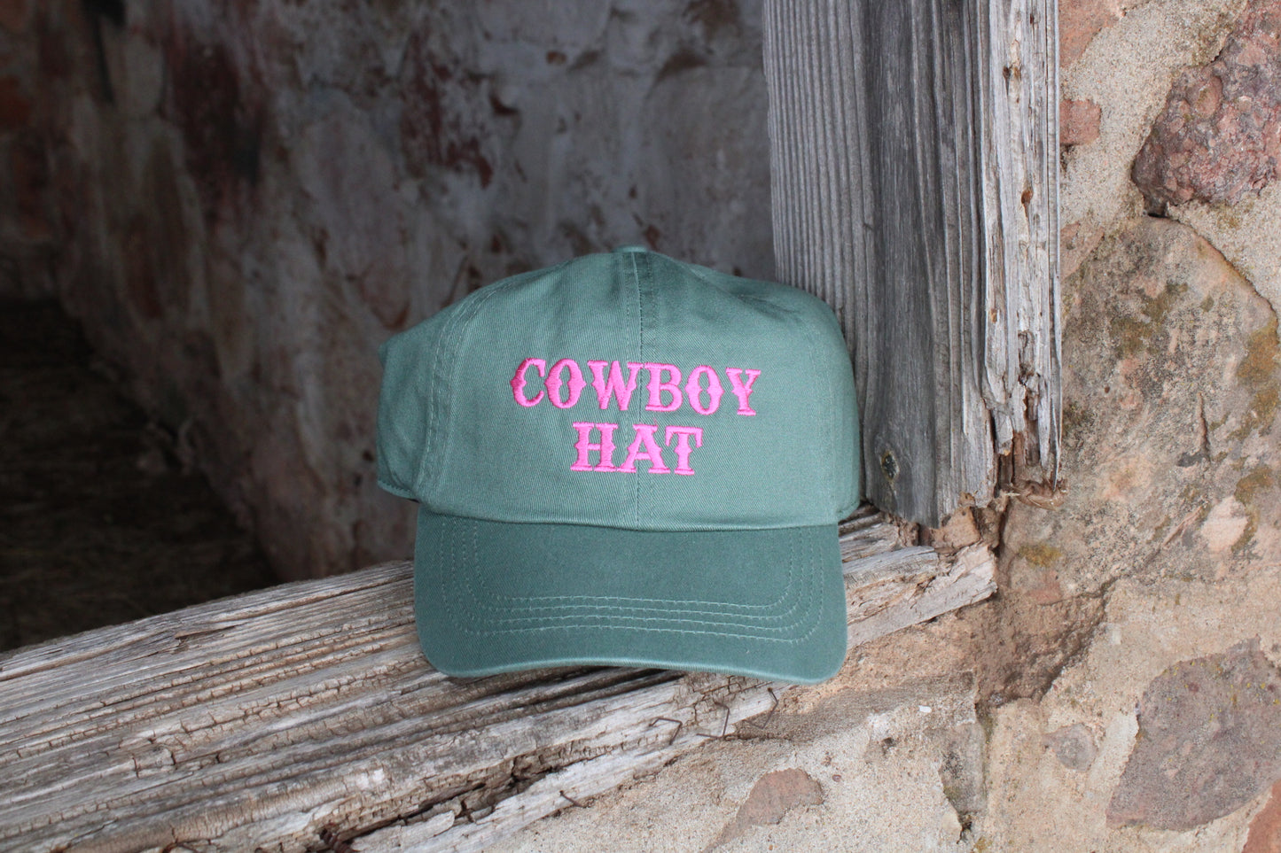 green hat with pink embroidery
