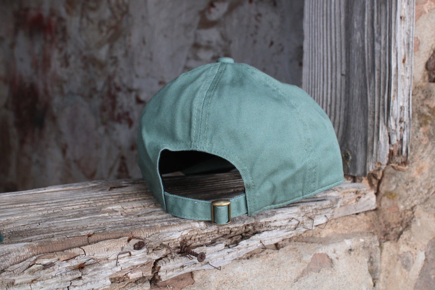green hat with pink embroidery